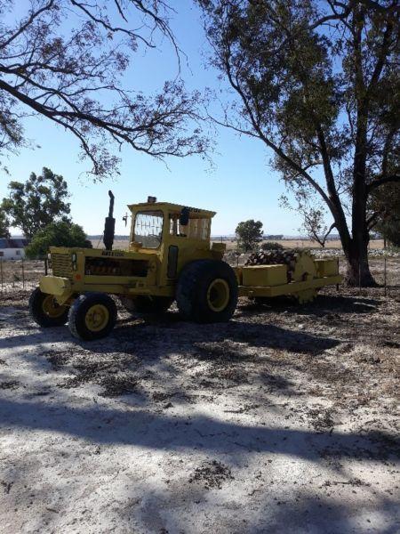 Bell 1206 Construction Tractor with Towed Padfoot Roller